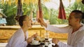 Man and woman eat and drink tasty beverages spending time in traditional local floating cafe on water. Loving happy