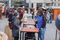 Man and woman are eating potato pancake between market stalls at Christmas market on the Cabbage Market on November 26, 2023 Brno