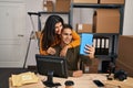 Man and woman ecommerce business workers having video call at ecommerce office Royalty Free Stock Photo