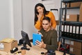 Man and woman ecommerce business workers having video call at ecommerce office Royalty Free Stock Photo