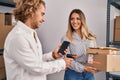 Man and woman ecommerce business workers scanning packages at office