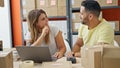 Man and woman ecommerce business workers using laptop smiling at office Royalty Free Stock Photo