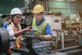 Man and woman engineer industry worker wearing hard hat in factory Royalty Free Stock Photo