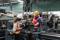 Man and woman engineer industry worker wearing hard hat in factory. Royalty Free Stock Photo