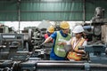 Man And Woman Engineer Industry Worker Wearing Hard Hat In Factory.