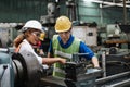 Man and woman engineer industry worker wearing hard hat in factory. Royalty Free Stock Photo