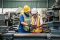 Man and woman engineer industry worker wearing hard hat in factory Royalty Free Stock Photo