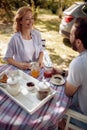 Man and woman enjoying on time together at countryside on beautiful picnic day
