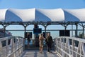 A man and a woman enter a ferry landing at Atlantic Avenue in Brooklyn Bridge Park