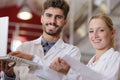 man and woman experts making tests in wine manufactory