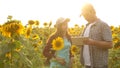 Man and woman farmers with a tablet work in the field with sunflowers. The concept of agriculture. agriculturist and