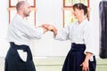 Man and woman fighting at Aikido martial arts school Royalty Free Stock Photo