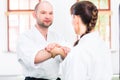 Man and woman fighting at Aikido martial arts school Royalty Free Stock Photo