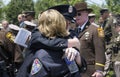 Man and woman firefighters hug each other during a police funeralpoliceman`sr funeral