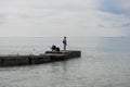 A man and a woman are fishing on the pier Royalty Free Stock Photo