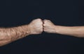 Man and woman are fist bumping. Fist Bump. Clash of two fists, vs. Gesture of giving respect or approval. Friends greeting.