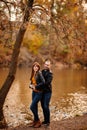 Man and woman flirt in autumn park near river Royalty Free Stock Photo