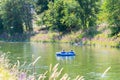 Man and woman float down Penticton River Channel on two-person inner-tube in summer Royalty Free Stock Photo