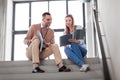 Man and woman with folders at office stairs Royalty Free Stock Photo