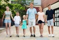 Man and woman with four kids smiling and taking walk