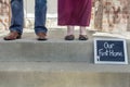 Feet of man and woman on front steps of home Royalty Free Stock Photo