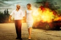 Man and a woman go away from burning car Royalty Free Stock Photo