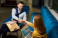 Man and a woman greet each other with a handshake