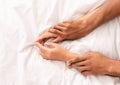 Man and woman hands having sex on bed