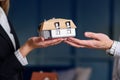 Man and woman hands holding 3d model of house. Royalty Free Stock Photo