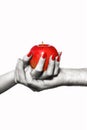 Man and woman hands holding forbidden fruit, selective coloring