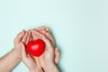 Man and woman hands holding red heart, health care, donate and family insurance concept, world heart day. Royalty Free Stock Photo