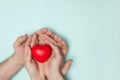 Man and woman hands holding red heart, health care, donate and family insurance concept, world heart day. Royalty Free Stock Photo