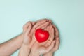 Man and woman hands holding red heart, health care, donate and family insurance concept, world heart day. Royalty Free Stock Photo