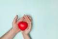 Man and woman hands holding red heart, health care, donate and family insurance concept, world heart day. Royalty Free Stock Photo