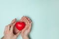 Man and woman hands holding red heart, health care, donate and family insurance concept, world heart day. Royalty Free Stock Photo