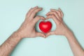 Man and woman hands holding red heart, health care, donate and family insurance concept, world heart day. Royalty Free Stock Photo