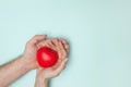 Man and woman hands holding red heart, health care, donate and family insurance concept, world heart day. Royalty Free Stock Photo