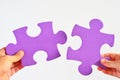 Man and woman hands holds two different puzzle pieces separated Royalty Free Stock Photo