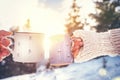 Man and woman hands in knitting mittens taking cups of hot drink Royalty Free Stock Photo