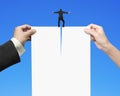 Man and woman hands tearing blank paper with businessman standing