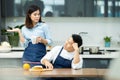 Man and woman, happy asian couple cooking together in kitchen at home Royalty Free Stock Photo