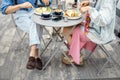 Stylish man and woman have a breakfast at cafe outdoors Royalty Free Stock Photo