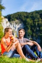 Man and woman having break hiking at river Royalty Free Stock Photo