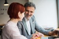 Man and woman having business meeting in a cafe, using laptop. Royalty Free Stock Photo