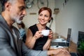 Man and woman having business meeting in a cafe, using laptop. Royalty Free Stock Photo