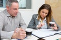 Man and woman having coffee in office Royalty Free Stock Photo