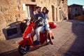 Man and woman having fun on moto scooters. couple riding motor scooter on road Royalty Free Stock Photo