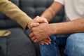 Man and woman having psychology session with hands together at psychology center Royalty Free Stock Photo