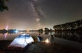 Man and woman having a rest on shore under night sky Royalty Free Stock Photo