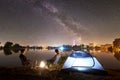 Man and woman having a rest on shore under night sky Royalty Free Stock Photo